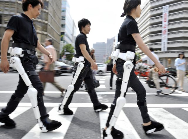 (ARCHIVOS) Esta imagen de archivo, tomada el 3 de agosto de 2009, muestra a los empleados de Cyberdyne de la empresa japonesa de robótica vistiendo el traje de robot. "HAL" (Hybrid Assistive Limb) mientras caminan por una calle de Tokio para una demostración.  HAL recibió una certificación de seguridad global el 27 de febrero de 2013, allanando el camino para la tecnología robótica humana de vanguardia en todo el mundo.  El certificado se otorgó en base a una versión preliminar de ISO 13482, el primer estándar de seguridad global para robots personales.  AFP PHOTO / ARCHIVOS / Yoshikazu TSUNO